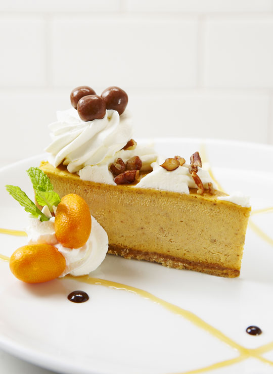 An image of a slice of pumpkin cheesecake